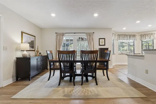 a view of a a dining room with furniture window and wooden floor