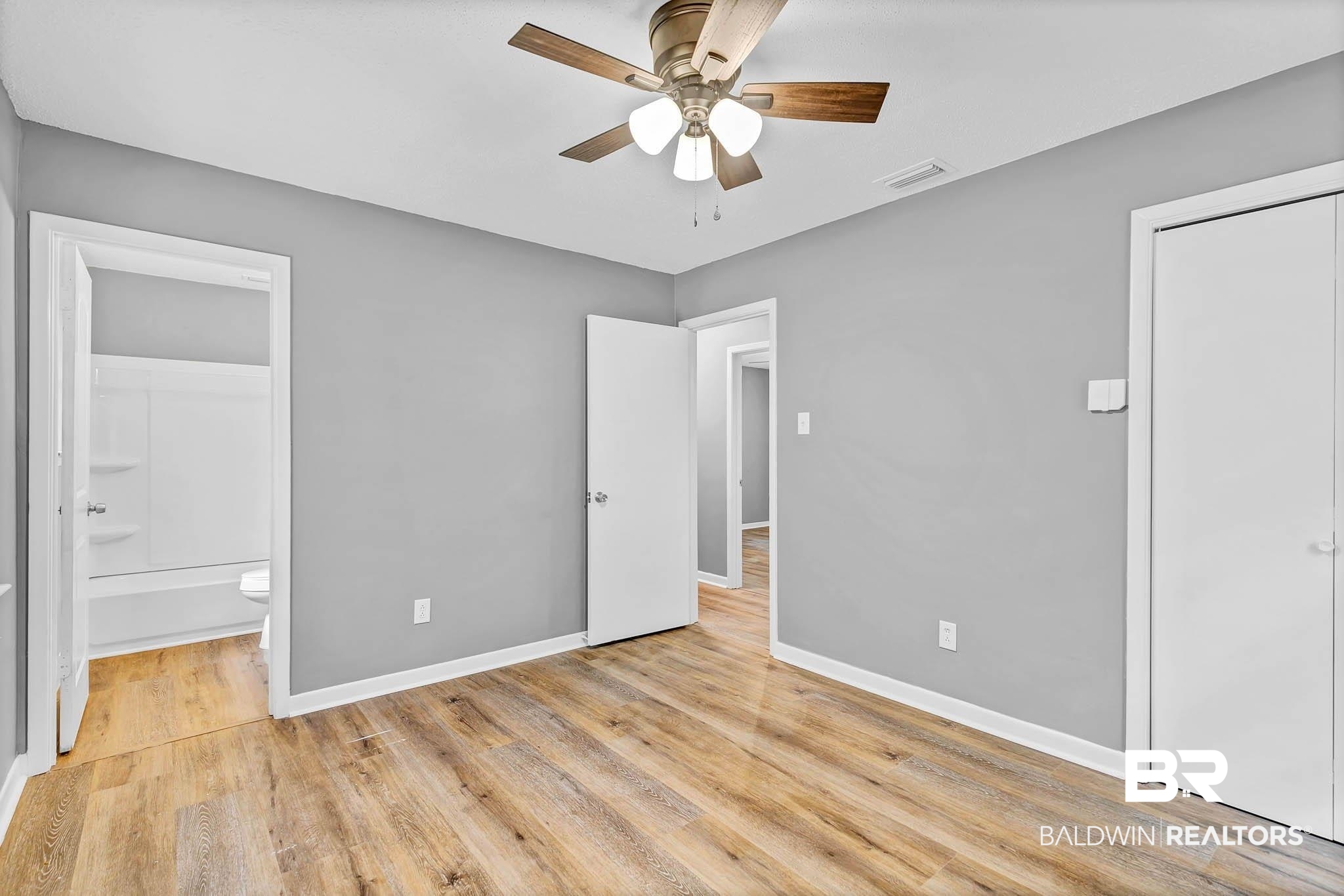 3304 Armond Drive Mobile, AL 36605 - Photo 30 of 62 Unfurnished bedroom featuring light wood finished floors, ensuite bathroom, and a ceiling fan