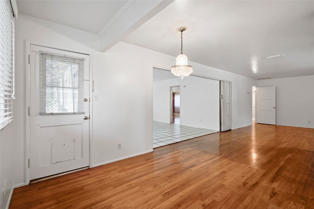 14335 Aztec Street Sylmar, CA 91342 - Photo 11 of 48 a view of an empty room with wooden floor and a window
