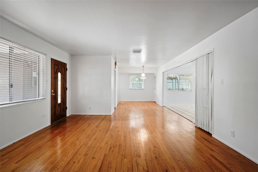 14335 Aztec Street Sylmar, CA 91342 - Photo 13 of 48 an empty room with wooden floor and windows