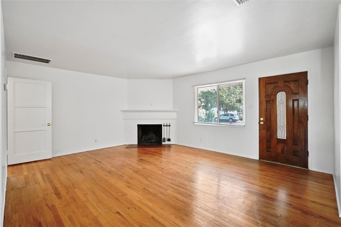 14335 Aztec Street Sylmar, CA 91342 - Photo 15 of 48 an empty room with wooden floor and windows
