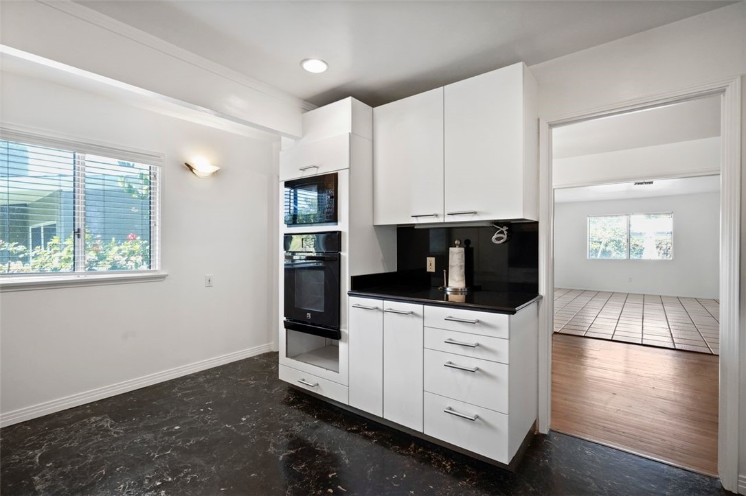 14335 Aztec Street Sylmar, CA 91342 - Photo 24 of 48 a kitchen with stainless steel appliances white cabinets and a refrigerator