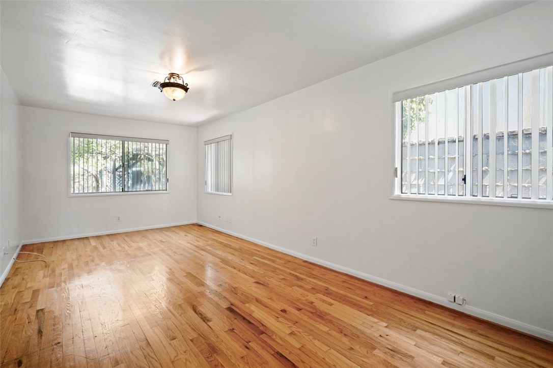 14335 Aztec Street Sylmar, CA 91342 - Photo 28 of 48 a view of an empty room with wooden floor and a window