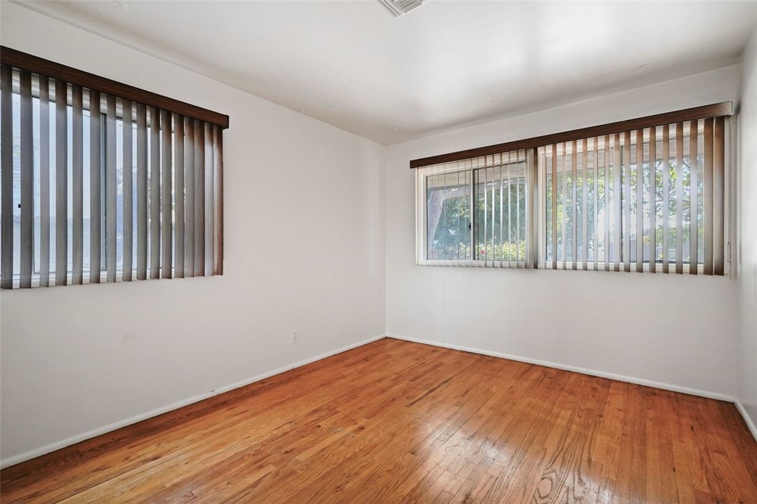 14335 Aztec Street Sylmar, CA 91342 - Photo 30 of 48 a view of an empty room with wooden floor and a window