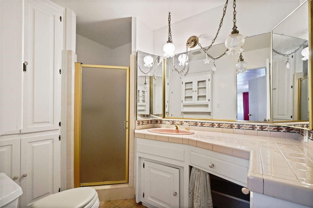 14335 Aztec Street Sylmar, CA 91342 - Photo 32 of 48 a bathroom with a sink a toilet a mirror and shower