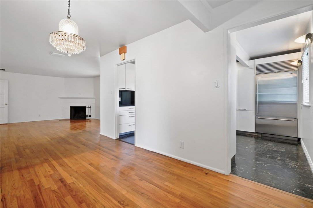 14335 Aztec Street Sylmar, CA 91342 - Photo 10 of 48 a view of a livingroom with wooden floor and a kitchen space