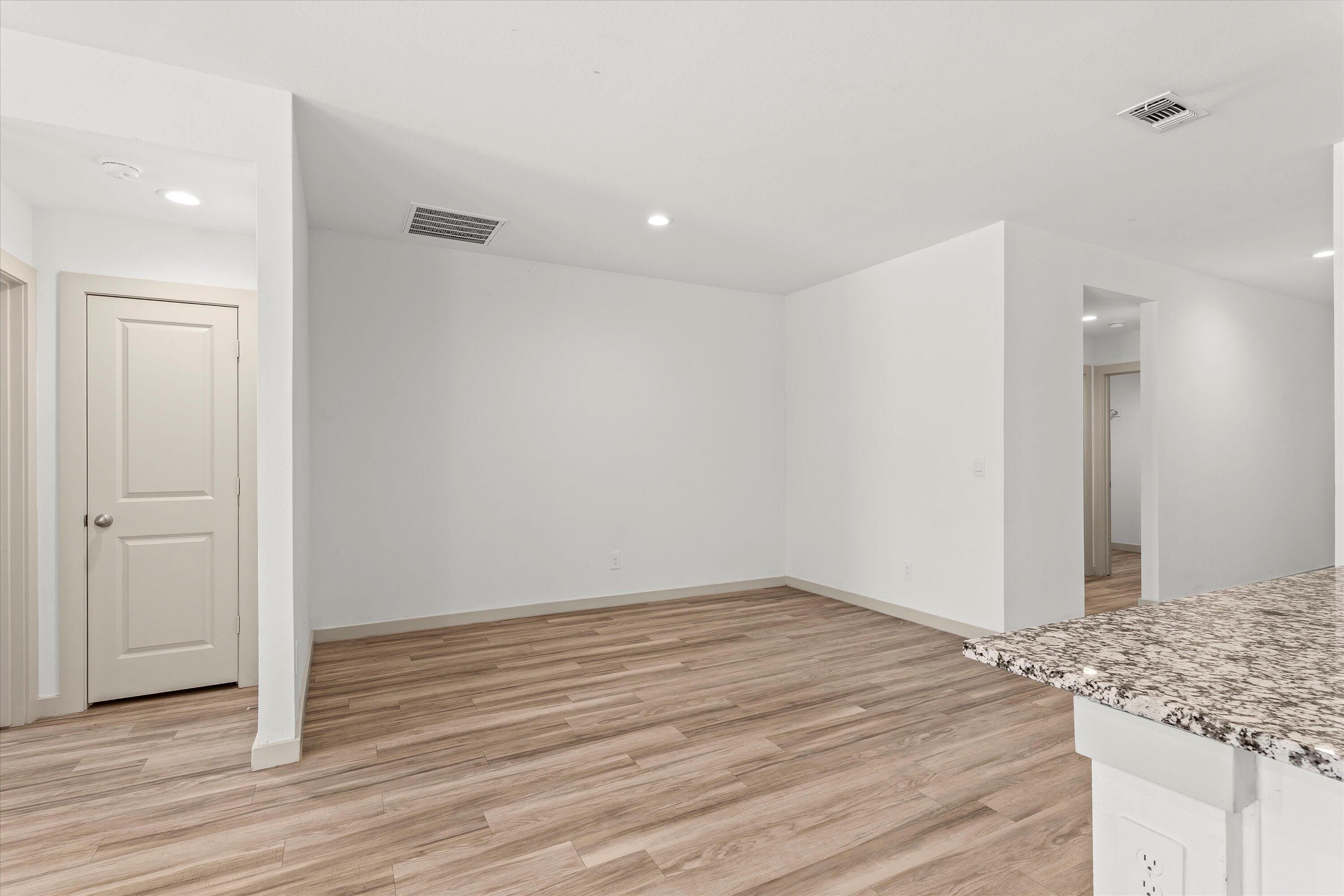 7416 9th Street Lubbock, TX 79416 - Photo 11 of 31 a view of a room with wooden floor and bathroom