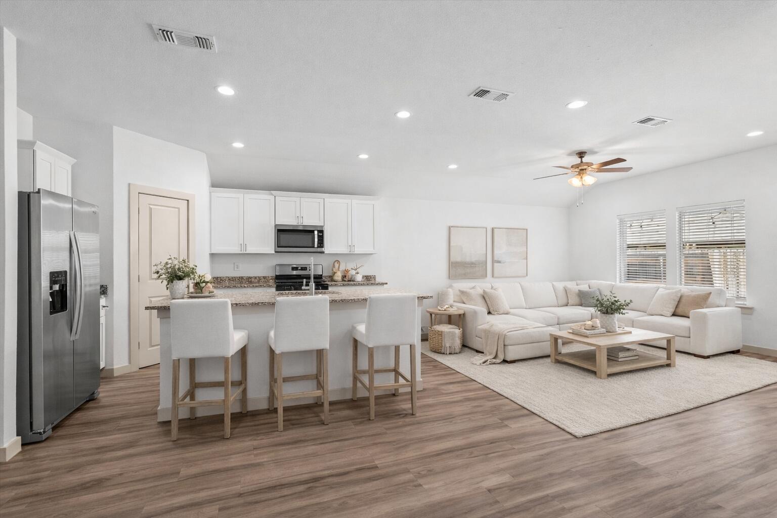 7416 9th Street Lubbock, TX 79416 - Photo 11 of 34 a living room with stainless steel appliances furniture and wooden floor