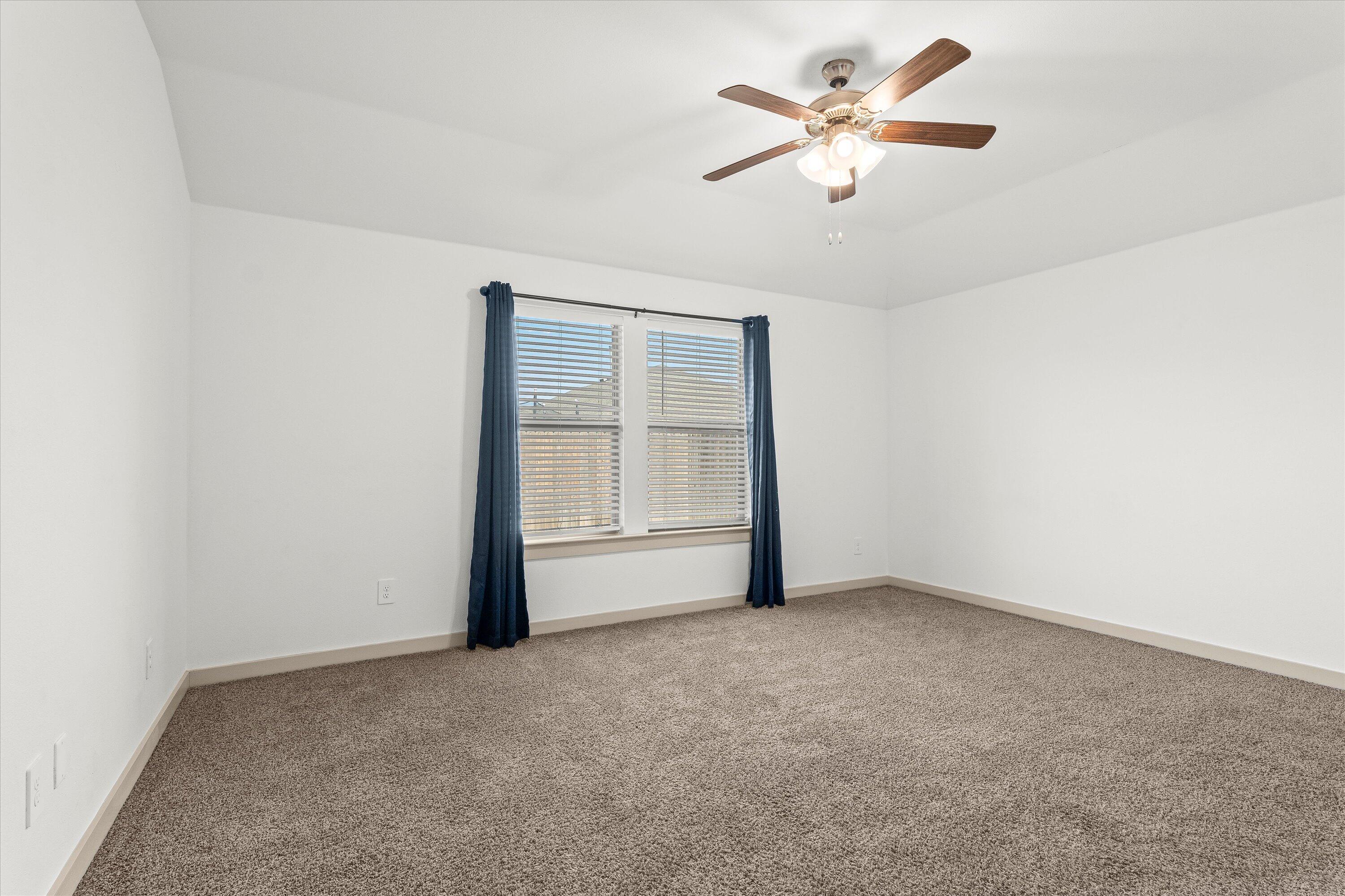 7416 9th Street Lubbock, TX 79416 - Photo 15 of 34 an empty room with closet and a ceiling fan