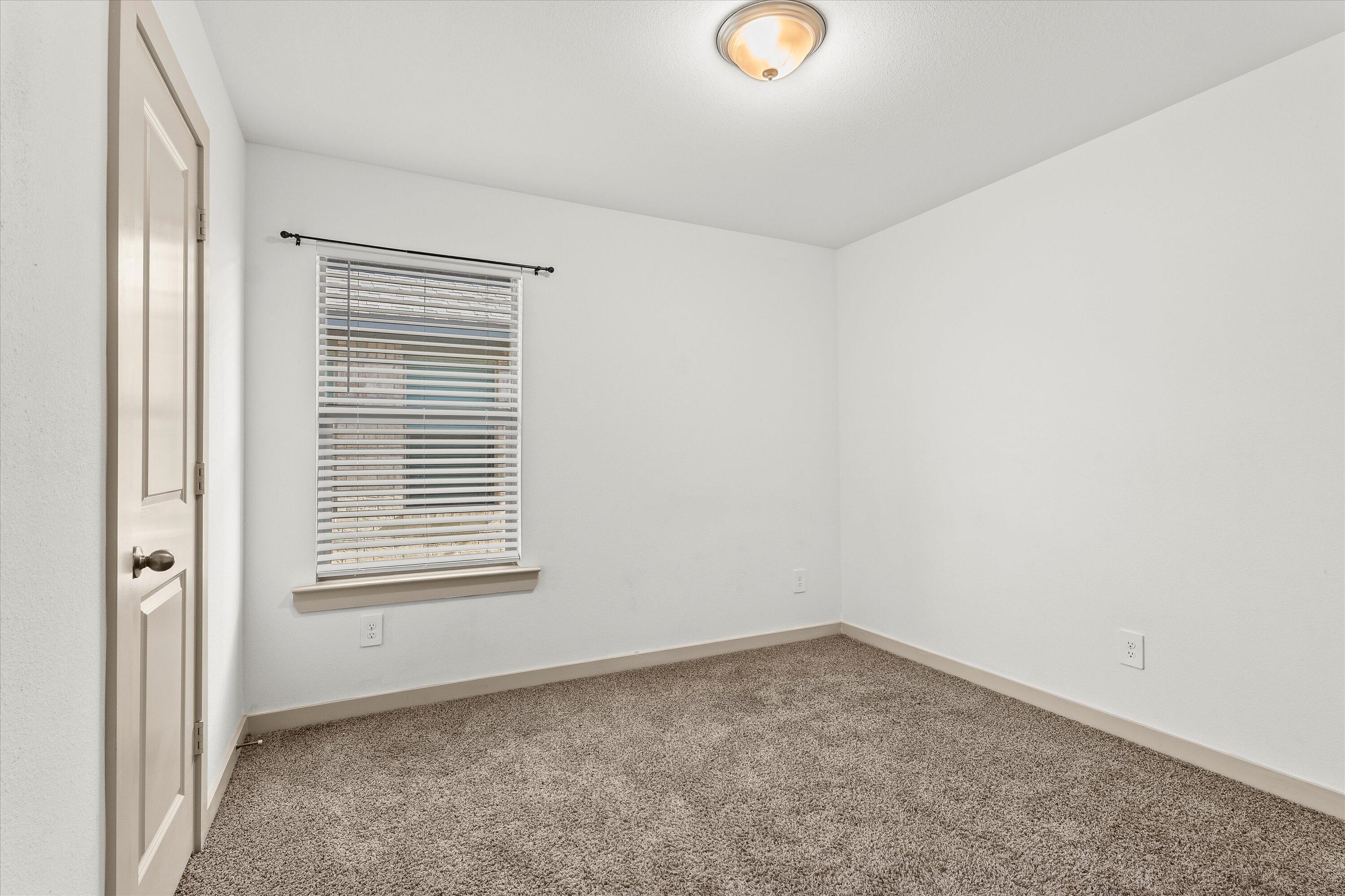 7416 9th Street Lubbock, TX 79416 - Photo 17 of 31 an empty room with a window