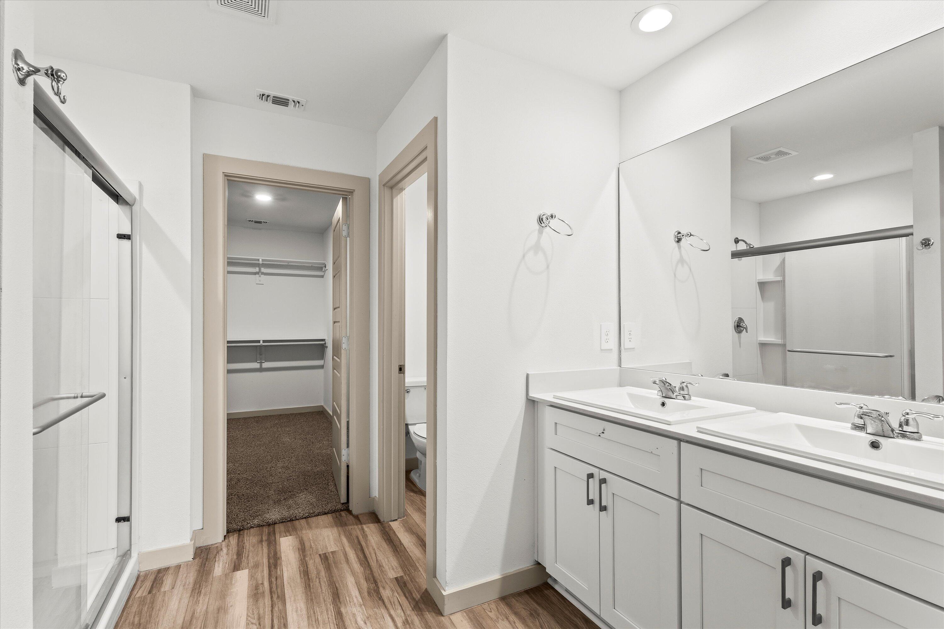 7416 9th Street Lubbock, TX 79416 - Photo 17 of 34 a bathroom with a sink a mirror and a shower