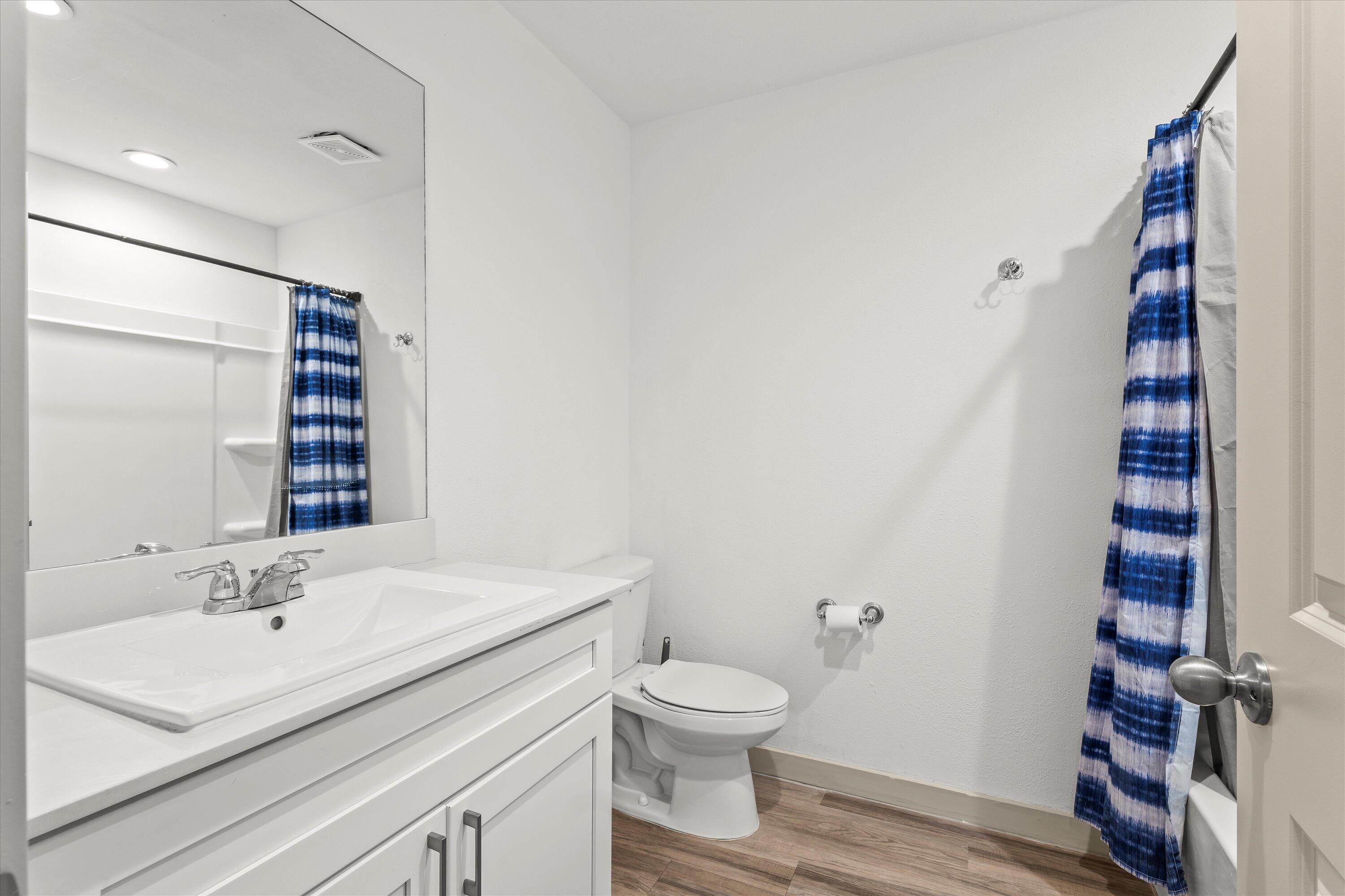 7416 9th Street Lubbock, TX 79416 - Photo 25 of 34 a bathroom with a sink toilet and shower