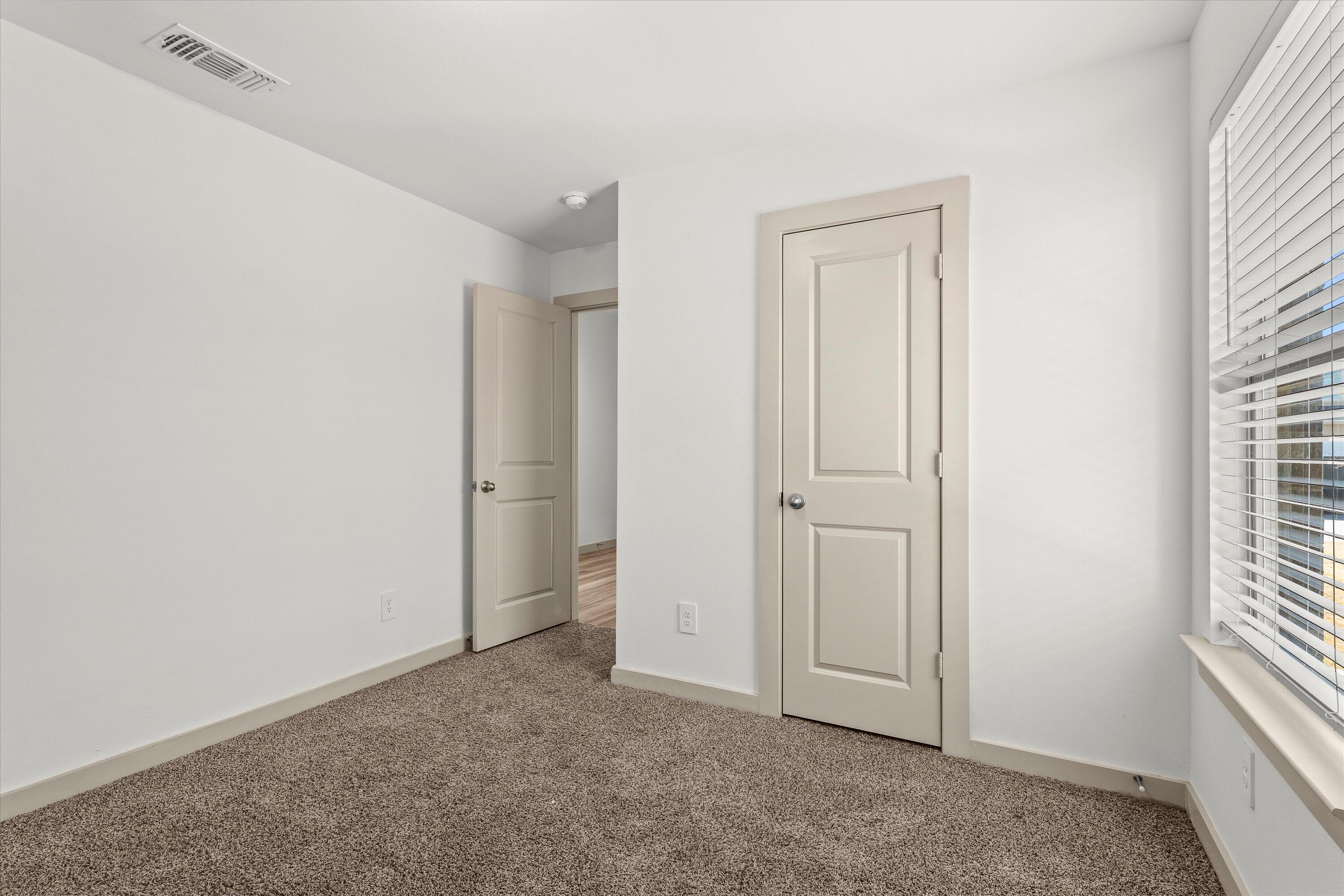 7416 9th Street Lubbock, TX 79416 - Photo 25 of 31 an empty room with windows and closet