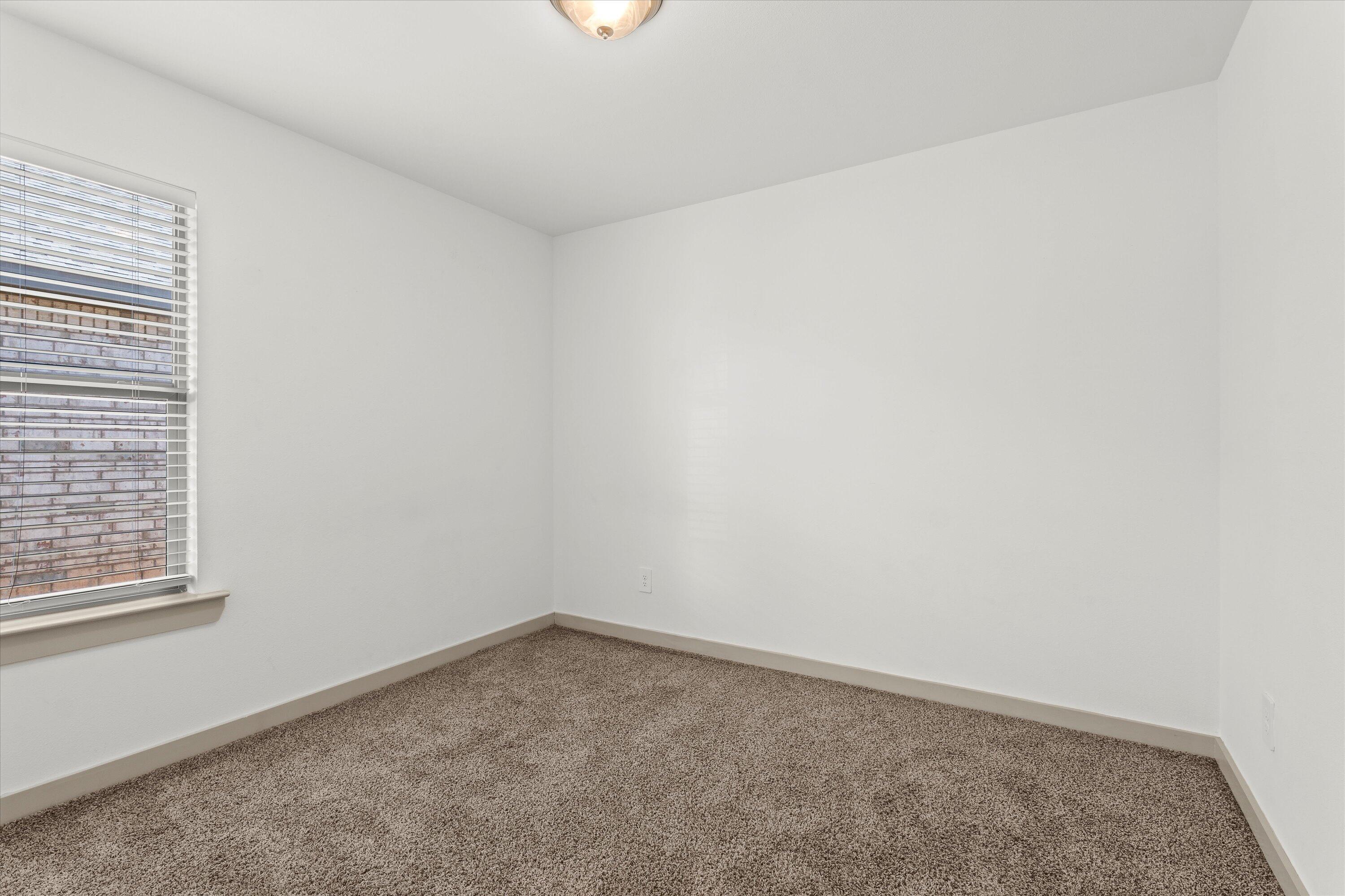 7416 9th Street Lubbock, TX 79416 - Photo 27 of 34 an empty room with a window