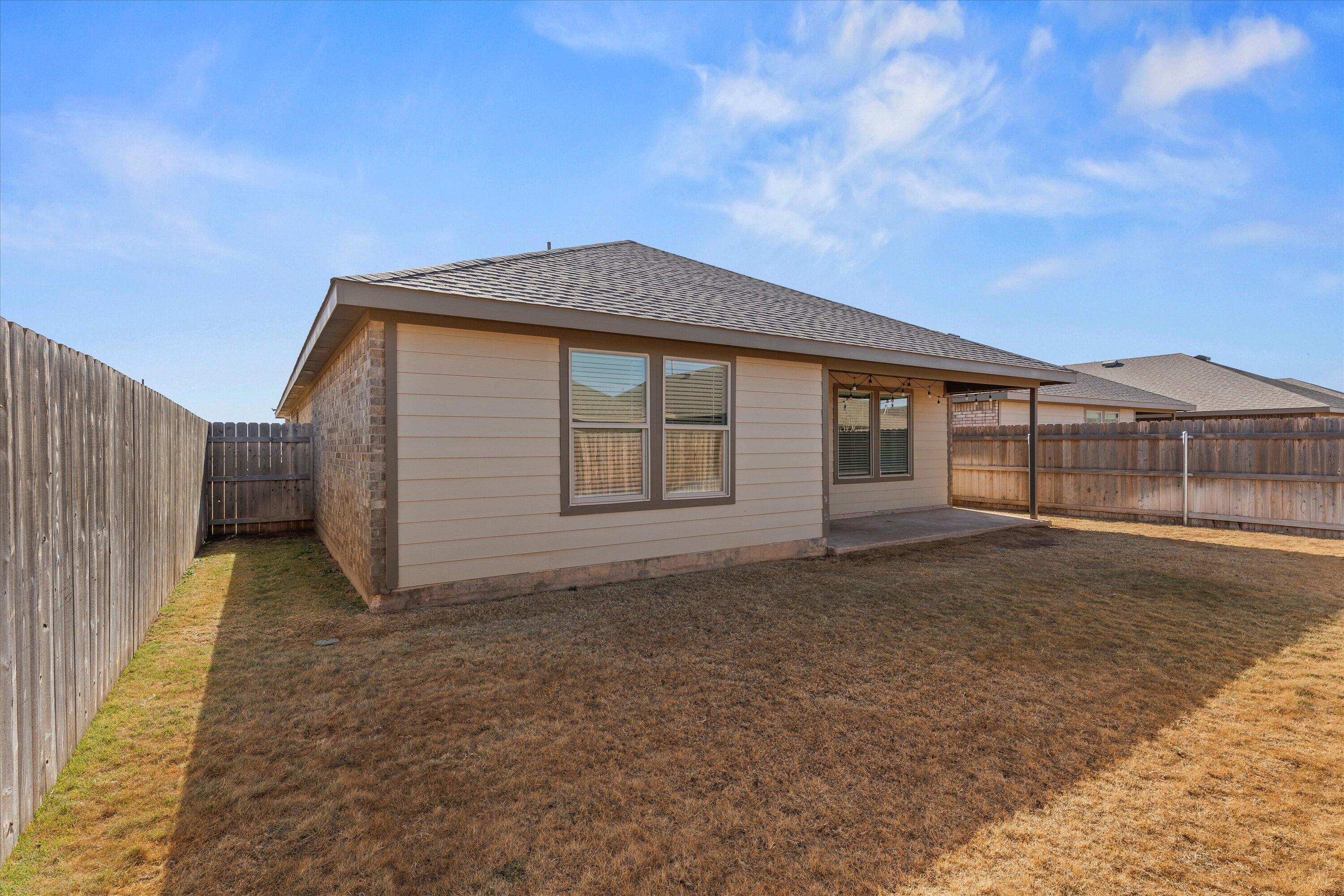 7416 9th Street Lubbock, TX 79416 - Photo 31 of 31 a front view of a house with a yard
