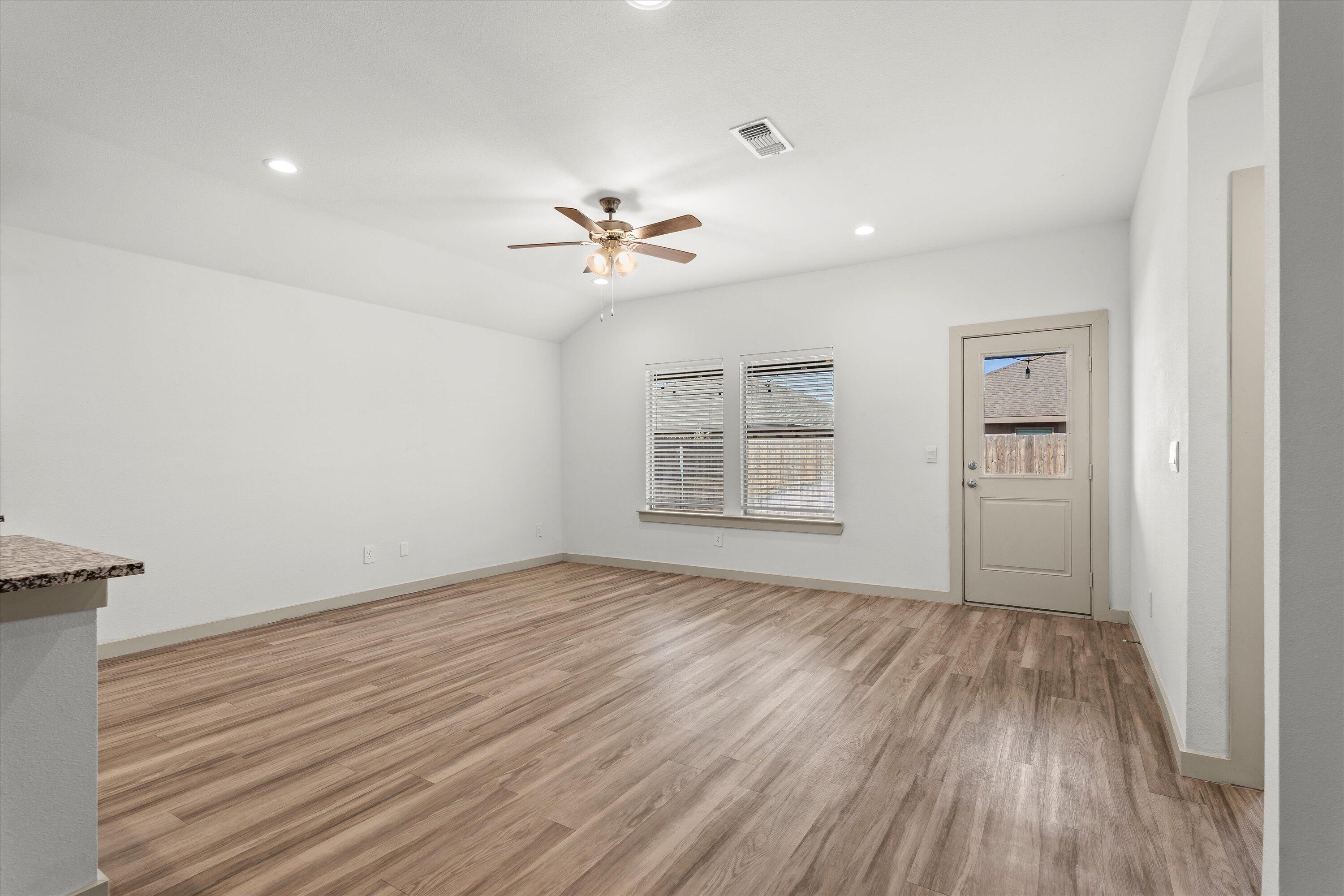 7416 9th Street Lubbock, TX 79416 - Photo 6 of 34 wooden floor in an empty room with a window