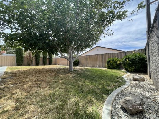 1133 West Benson Avenue Ridgecrest, CA 93555 - Photo 33 of 34 a view of a house with a yard