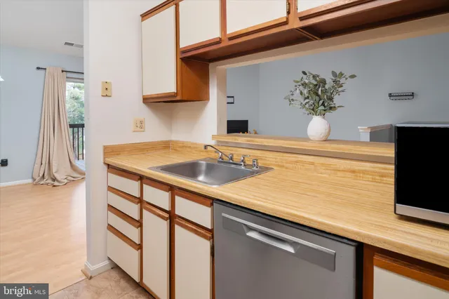 a kitchen with a sink and cabinets