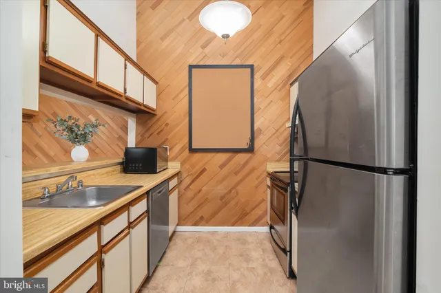 a kitchen with a refrigerator a stove and a sink
