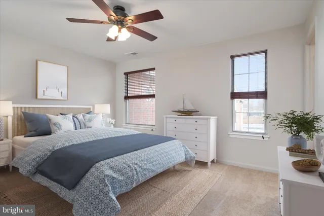 a bedroom with a bed dresser and a window