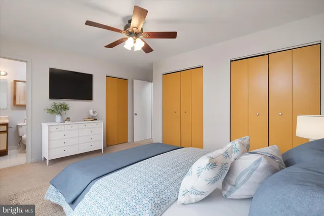 a bedroom with a bed dresser and a flat screen tv