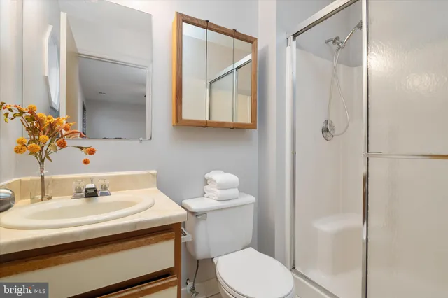 a bathroom with a sink toilet and shower