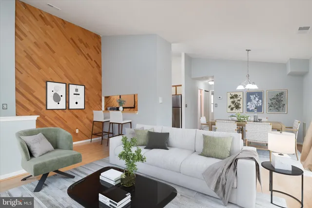 a living room with furniture and a chandelier
