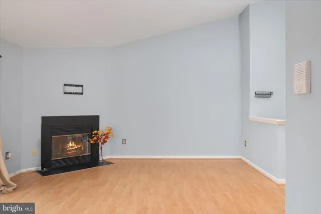 a view of an empty room with a fireplace