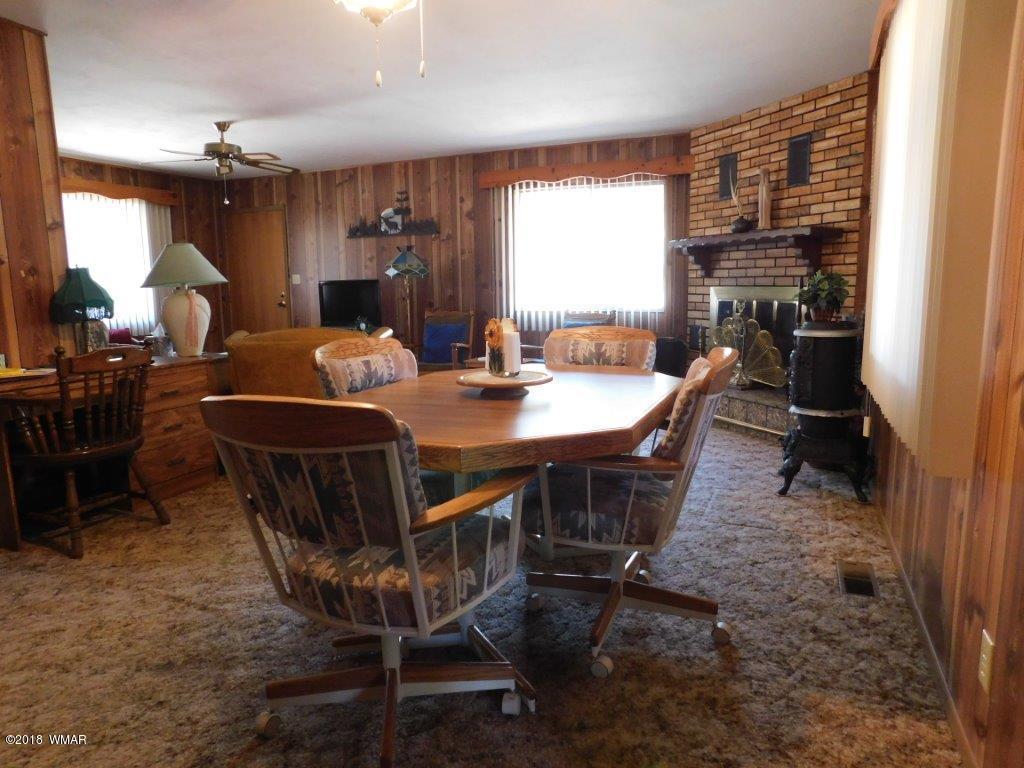 2021 Lumber Valley Road Overgaard, AZ 85933 - Photo 6 of 39 a dining room with a wooden table and chairs