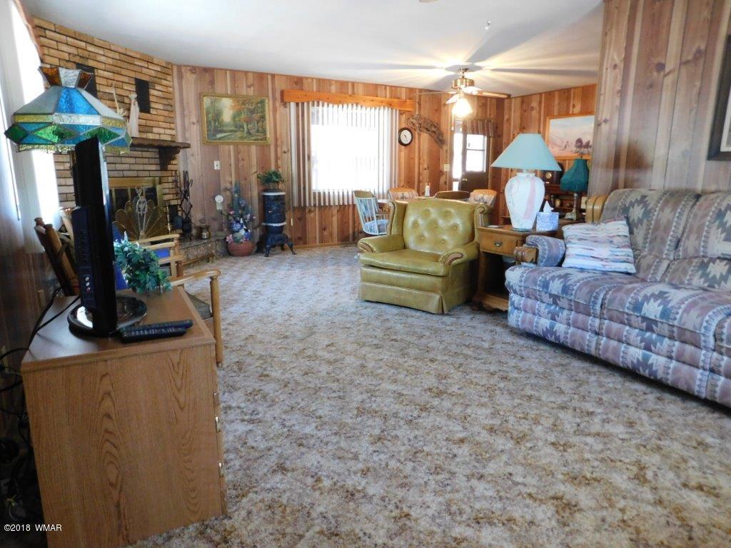 2021 Lumber Valley Road Overgaard, AZ 85933 - Photo 7 of 39 a living room with furniture and a chandelier
