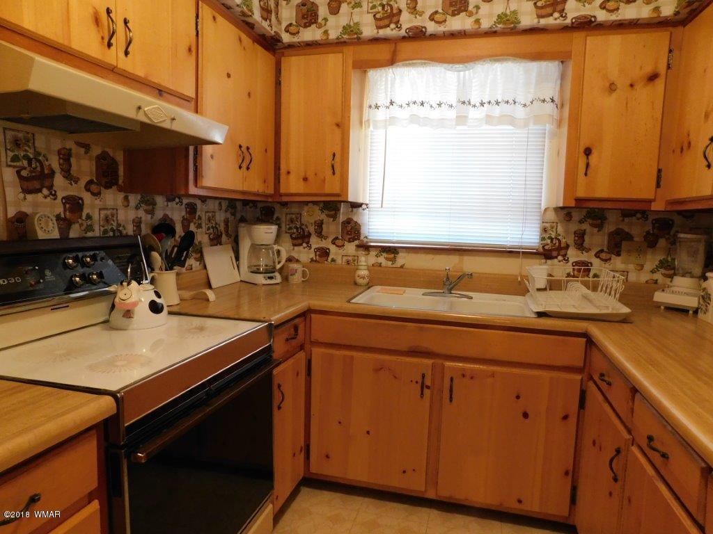 2021 Lumber Valley Road Overgaard, AZ 85933 - Photo 9 of 39 a kitchen with a sink and cabinets