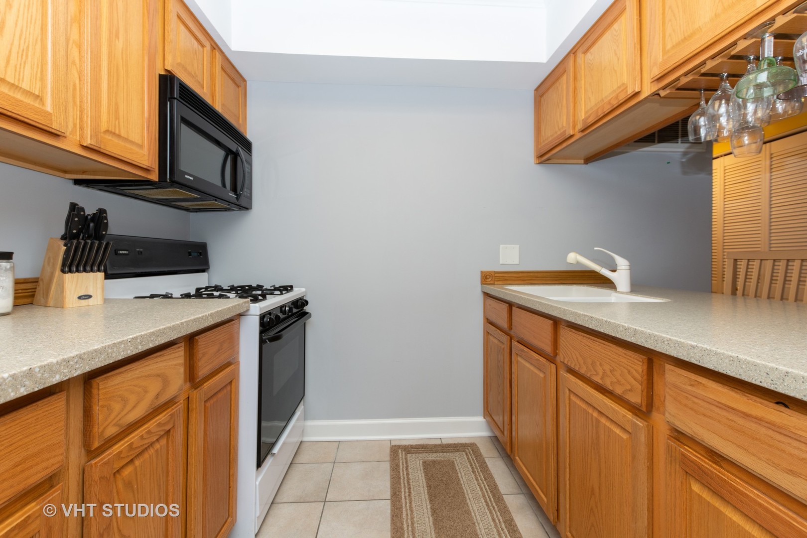 9830 Sayre Avenue, Unit 1 Chicago Ridge, IL 60415 - Photo 5 of 11 a kitchen with stainless steel appliances a sink a stove cabinets and a microwave