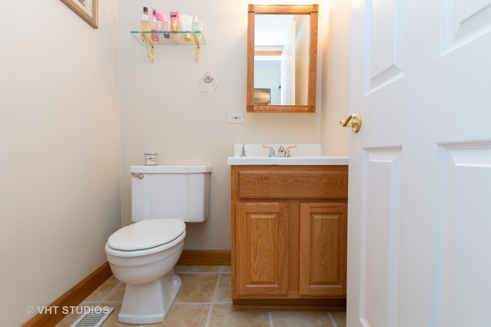 9830 Sayre Avenue, Unit 1 Chicago Ridge, IL 60415 - Photo 8 of 11 a bathroom with a toilet sink and mirror