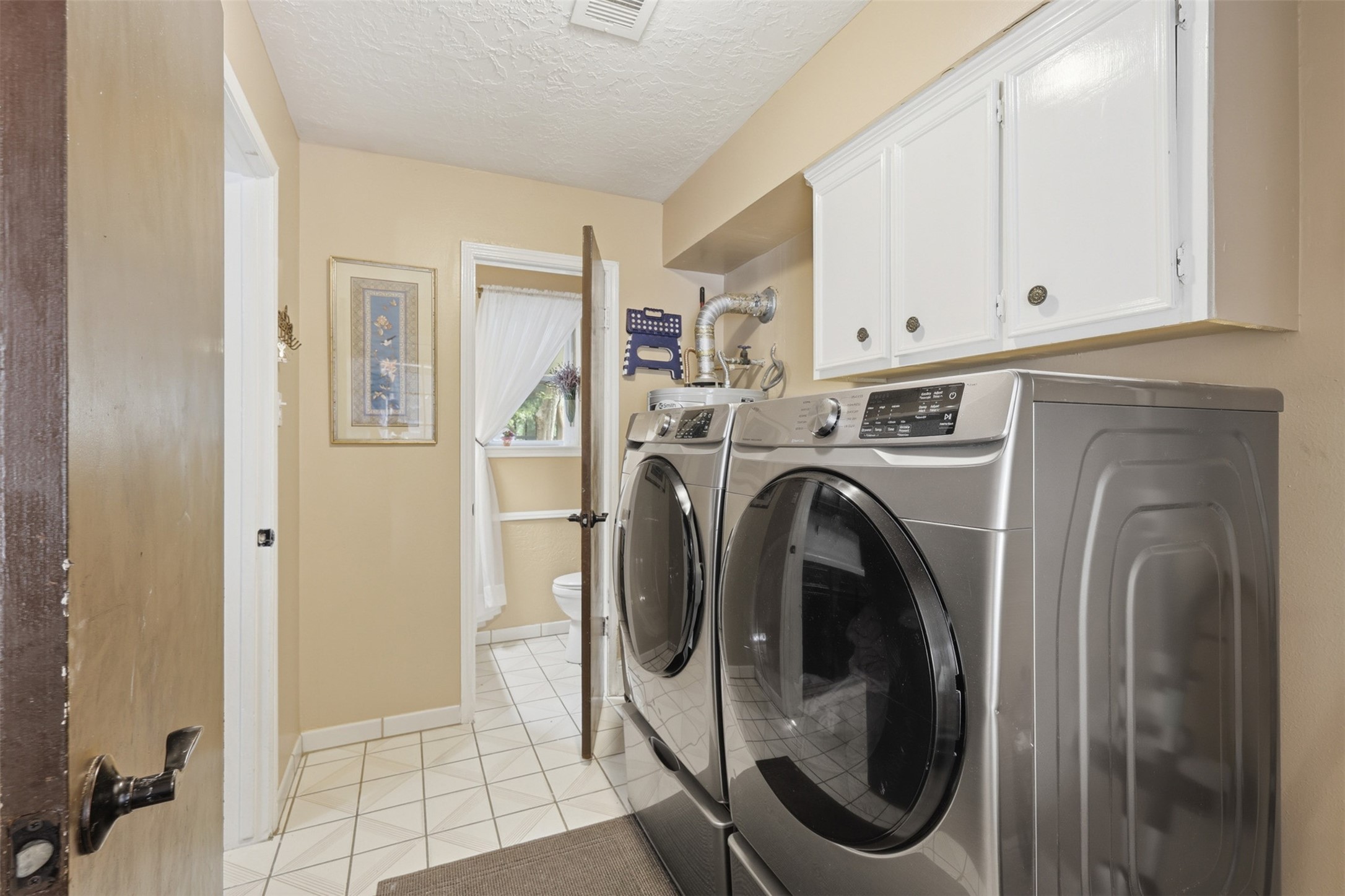 7010 River Mill Drive Spring, TX 77379 - Photo 13 of 29 a view of a hallway with washer and dryer