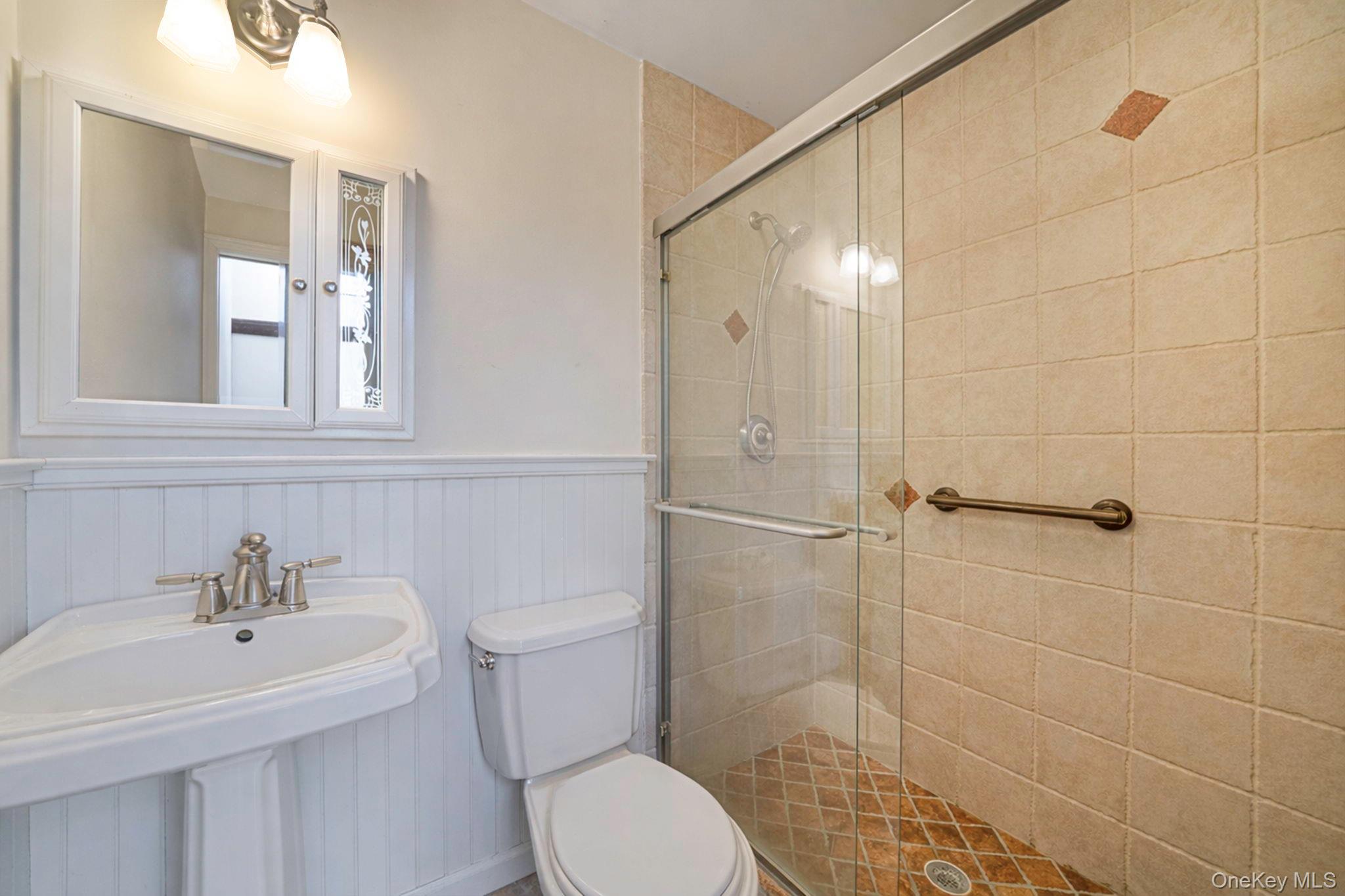 1 Spring Hollow Road Nissequogue, NY 11780 - Photo 15 of 17 a bathroom with a sink toilet and shower