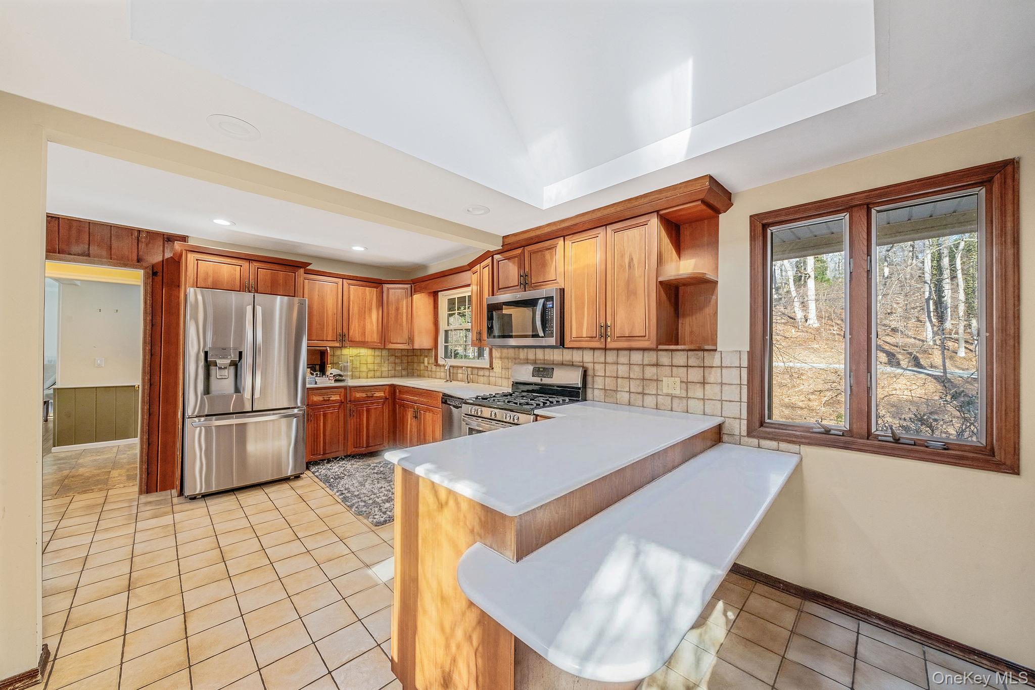 1 Spring Hollow Road Nissequogue, NY 11780 - Photo 5 of 17 a large kitchen with a large window and stainless steel appliances