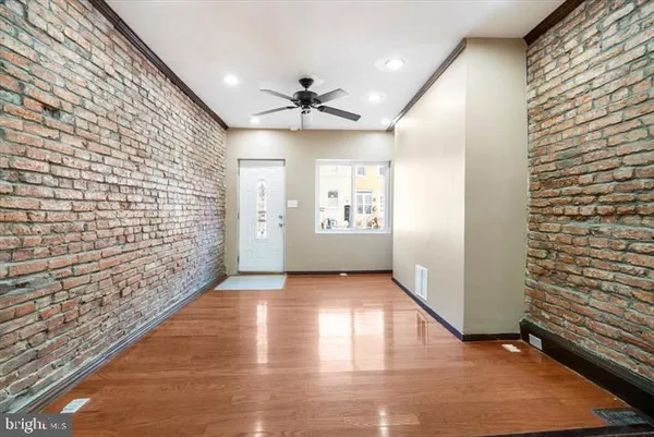 wooden floor in an empty room with a window