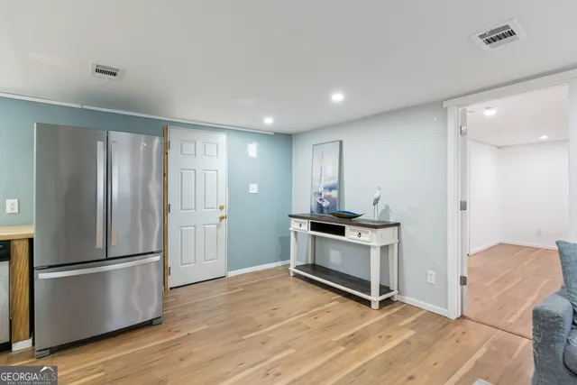 a kitchen with stainless steel appliances granite countertop a refrigerator a stove and a wooden floors