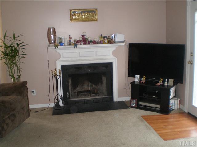 8017 Perry Creek Road Raleigh, NC 27616 - Photo 3 of 12 a living room with furniture and a fireplace