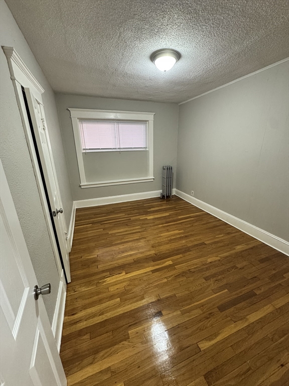 10 Marengo Park, Unit 3L Springfield, MA 01108 - Photo 4 of 8 an empty room with wooden floor and windows