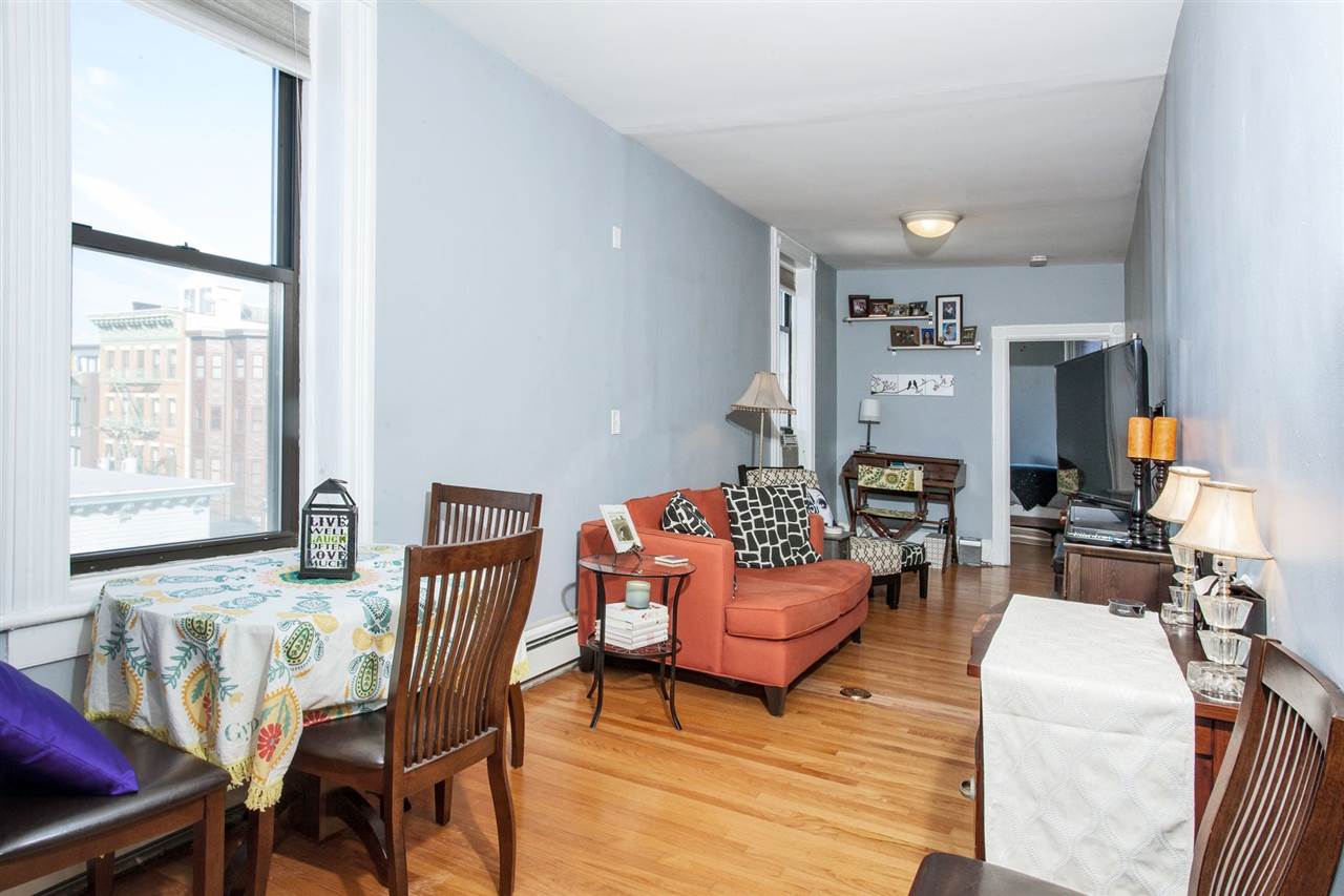 422 Madison Street, Unit 4R(7) Hoboken, NJ 07030 - Photo 1 of 1 a living room with furniture and a large window
