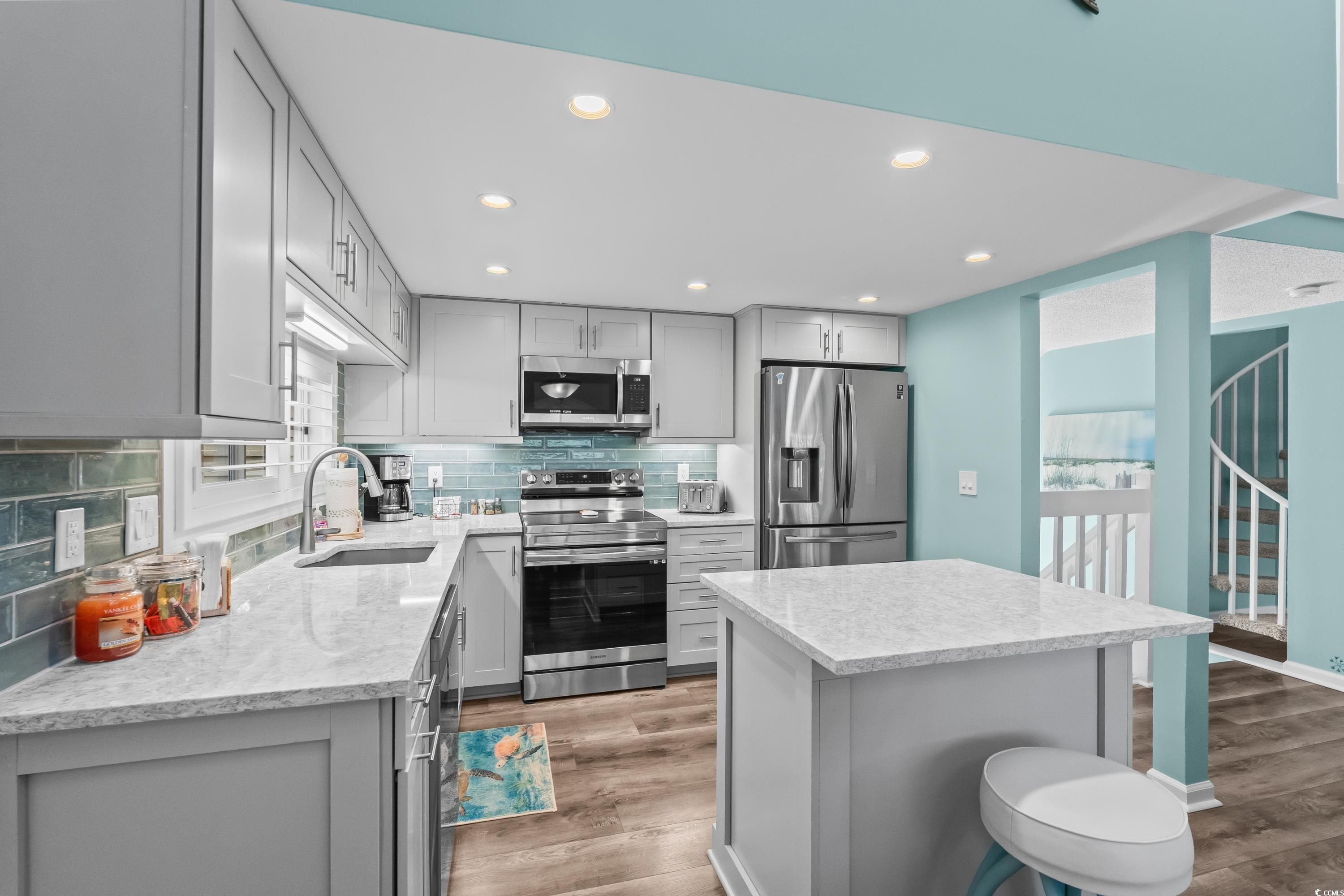 304 Cumberland Terrace, Unit 2F Myrtle Beach, SC 29572 - Photo 12 of 40 Kitchen with gray cabinets, appliances with stainless steel finishes, backsplash, recessed lighting, and light wood-type flooring