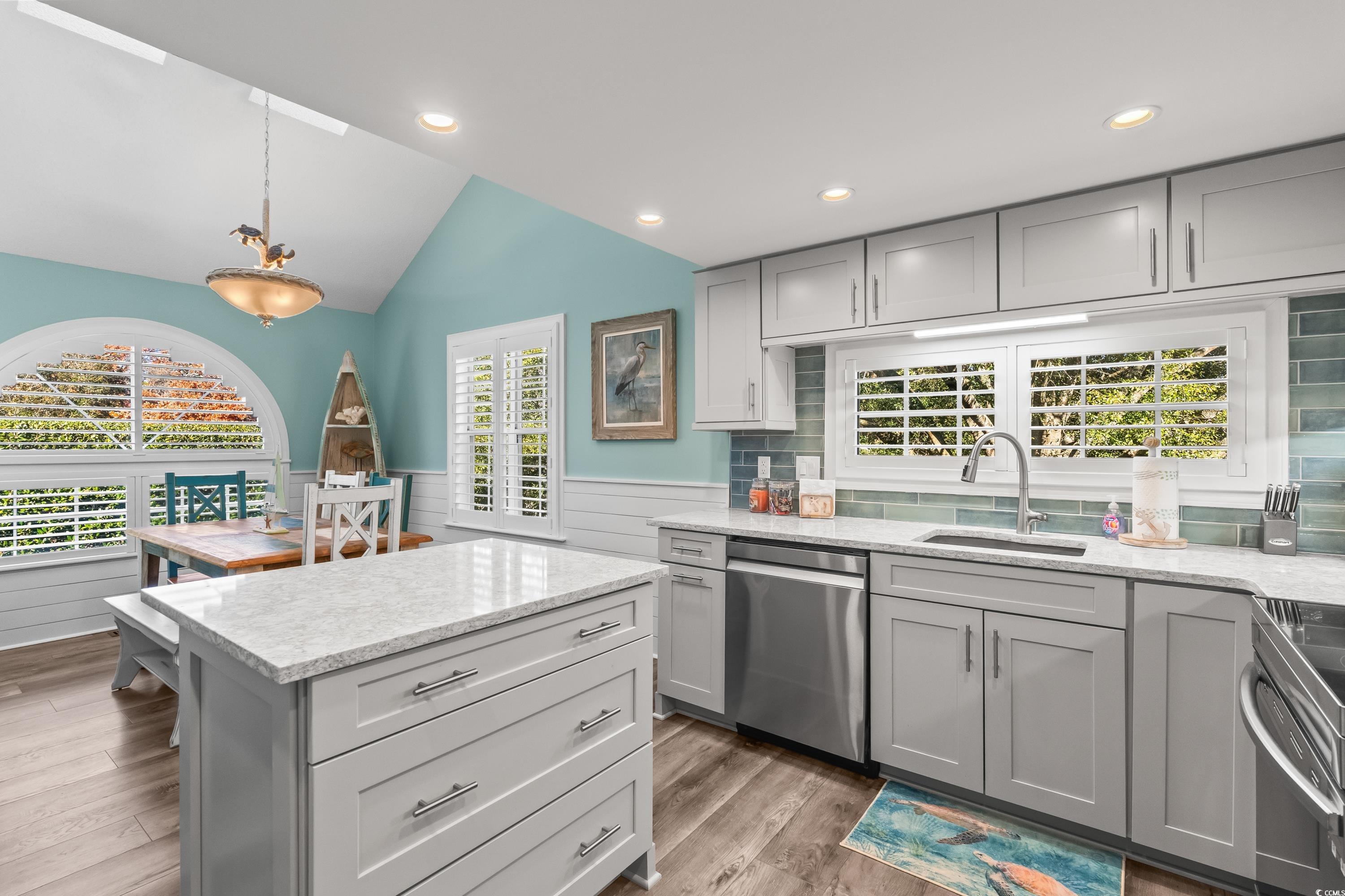 304 Cumberland Terrace, Unit 2F Myrtle Beach, SC 29572 - Photo 14 of 40 Kitchen with gray cabinets, vaulted ceiling, light stone counters, recessed lighting, and wainscoting