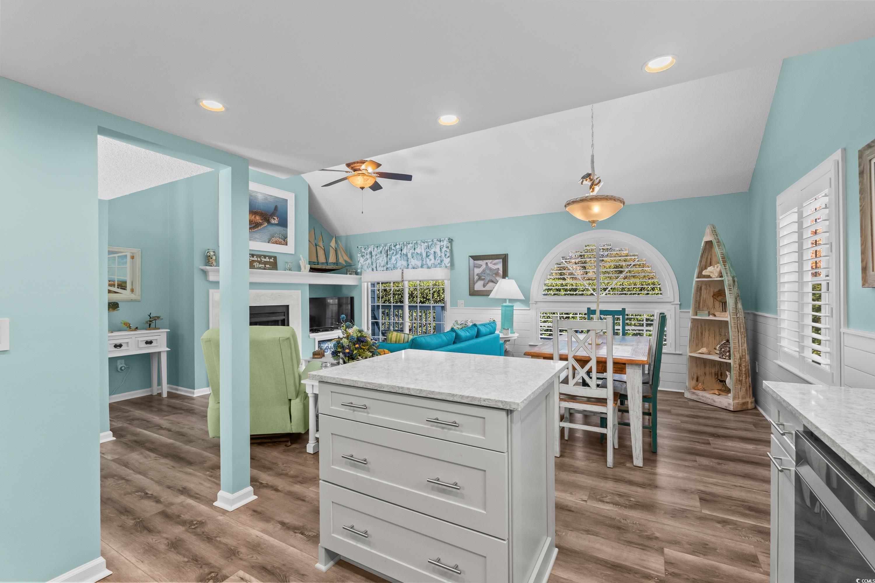 304 Cumberland Terrace, Unit 2F Myrtle Beach, SC 29572 - Photo 15 of 40 Kitchen with light stone counters, decorative light fixtures, lofted ceiling, stainless steel dishwasher, and dark wood-style flooring