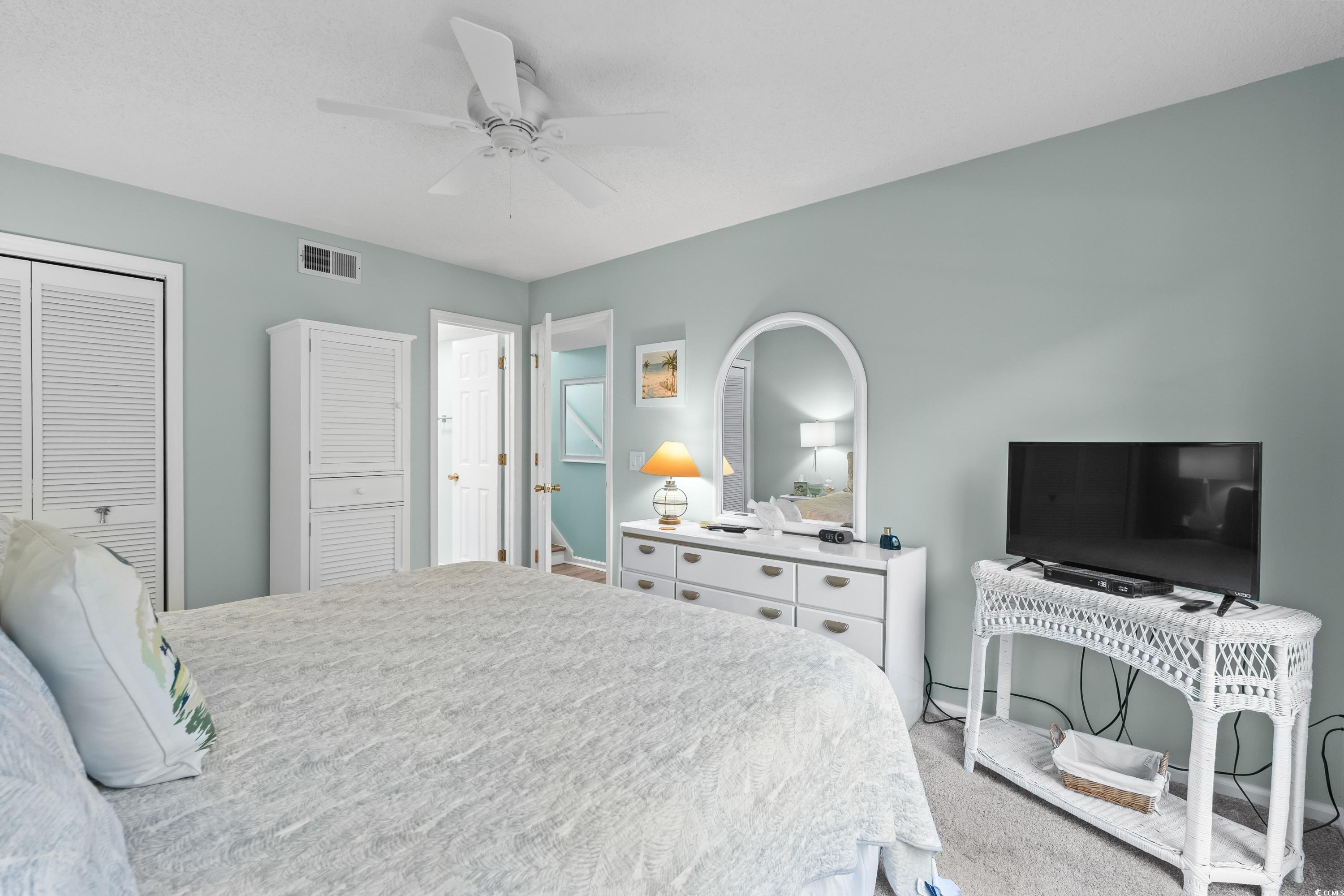 304 Cumberland Terrace, Unit 2F Myrtle Beach, SC 29572 - Photo 24 of 40 Bedroom featuring a closet, carpet floors, and a ceiling fan