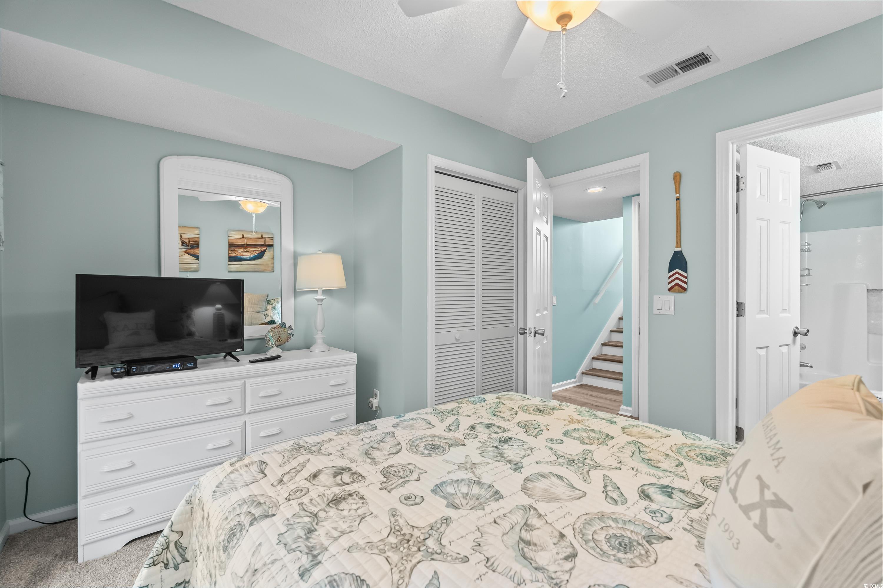 304 Cumberland Terrace, Unit 2F Myrtle Beach, SC 29572 - Photo 29 of 40 Carpeted bedroom with a ceiling fan and a closet
