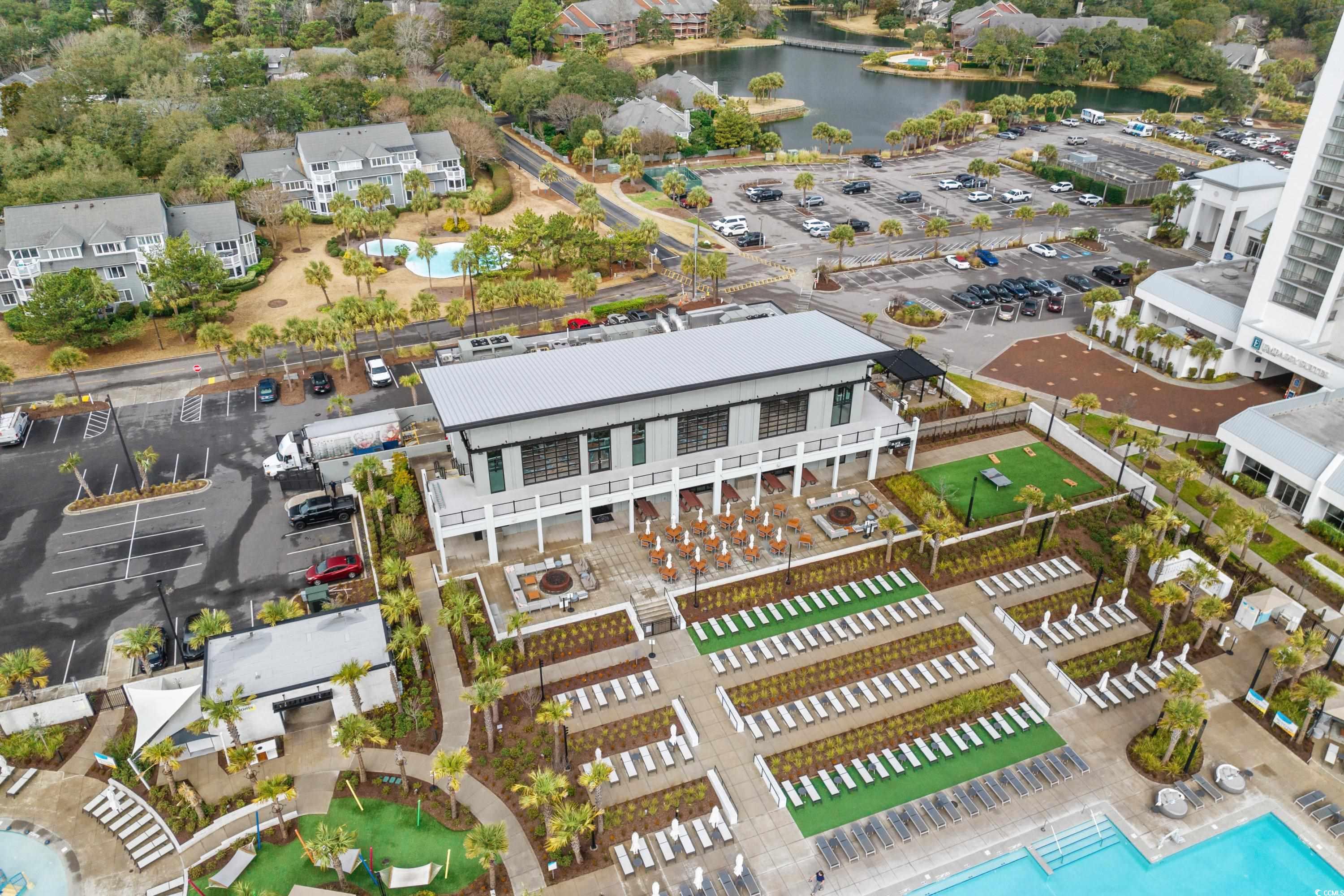 304 Cumberland Terrace, Unit 2F Myrtle Beach, SC 29572 - Photo 38 of 40 Drone / aerial view of a pool area and a large body of water