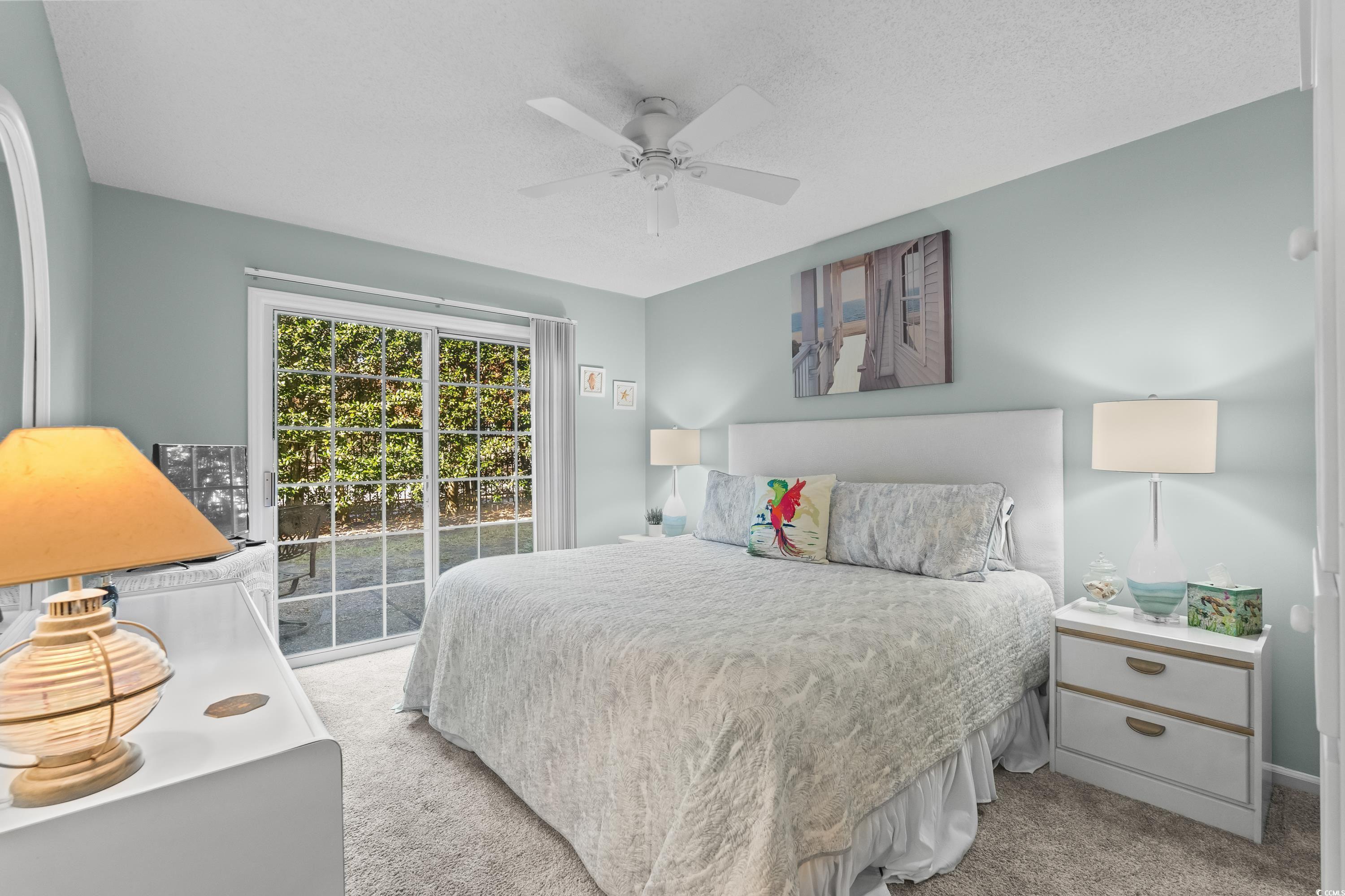 304 Cumberland Terrace, Unit 2F Myrtle Beach, SC 29572 - Photo 5 of 40 Carpeted bedroom featuring access to exterior and ceiling fan