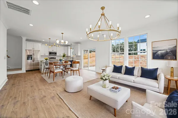 a living room with furniture and kitchen view