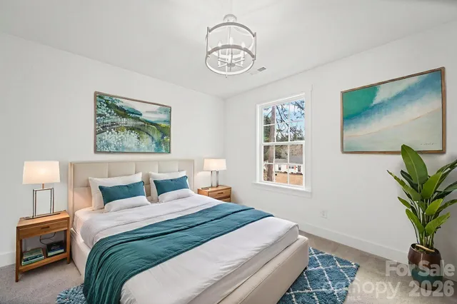 a bedroom with a large bed and a window